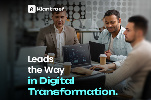 Team collaborating around laptops with dashboards, representing leadership in digital transformation and innovation.