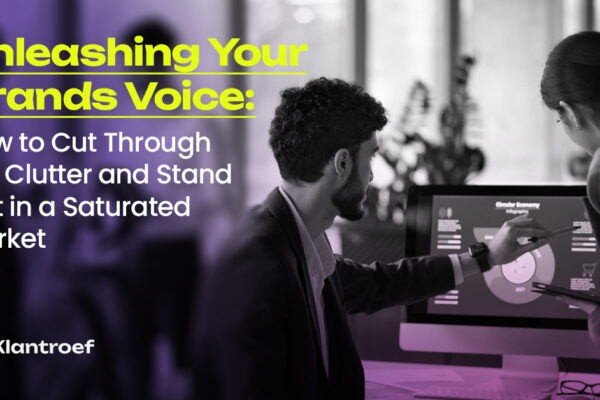 Professionals analyzing brand data on screen, brainstorming to sharpen brand voice and market positioning.