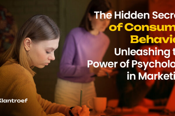 A woman in deep thought writing in a cozy workspace, with others brainstorming in the background — symbolizing psychological insights in marketing.
