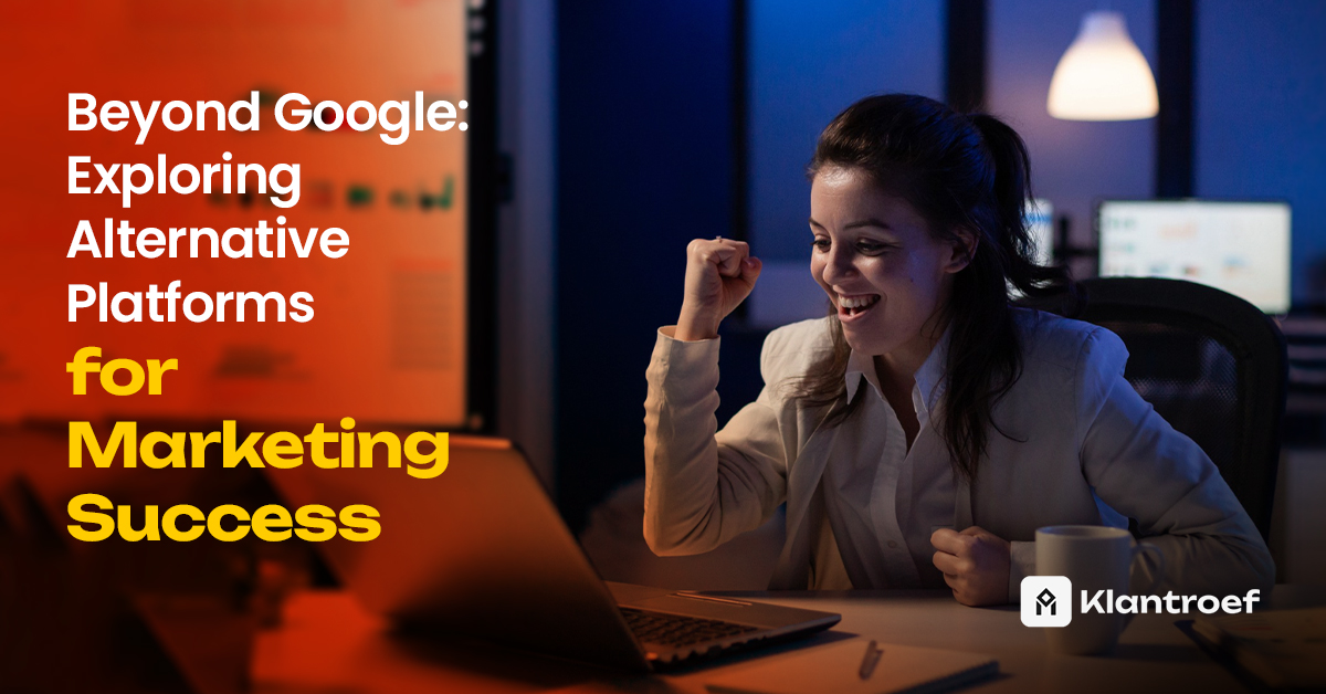 A woman celebrates a marketing win at her desk, smiling with a raised fist while looking at her laptop in a modern, dim-lit workspace.