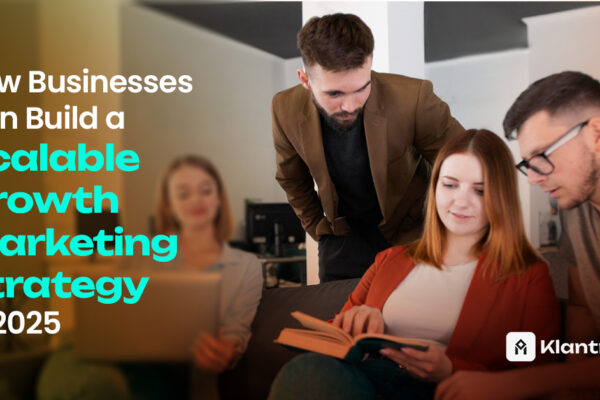 A team of professionals collaborating over a book and laptop, symbolizing planning for a scalable growth marketing strategy.