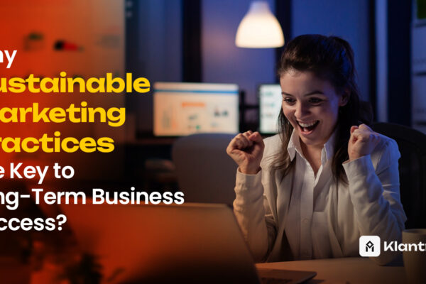 A delighted woman in a white shirt celebrates in front of her laptop in a dimly lit office, suggesting business success driven by sustainable strategies.