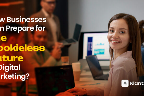 A smiling woman sits at a conference table with her team, surrounded by laptops and data dashboards, symbolizing strategic preparation for a cookieless digital marketing era.