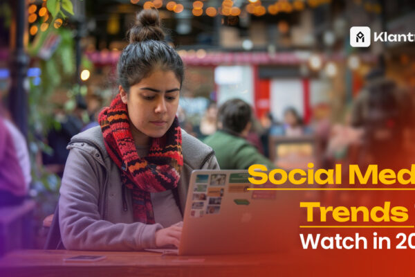 A young woman in a cozy scarf working on a laptop at a vibrant café, with the text "Social Media Trends to Watch in 2025" and Klantroef branding overlaid.