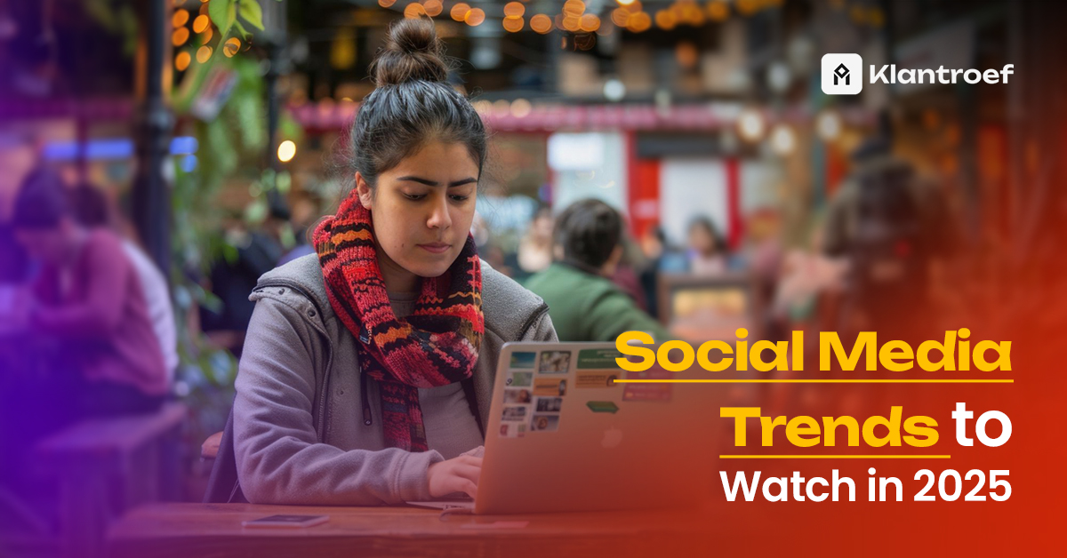 A young woman in a cozy scarf working on a laptop at a vibrant café, with the text "Social Media Trends to Watch in 2025" and Klantroef branding overlaid.