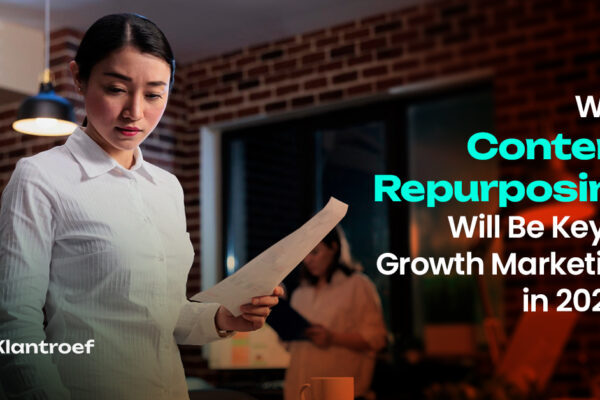 A professional woman in a white shirt reviewing documents in an office, representing content evaluation and repurposing strategies.