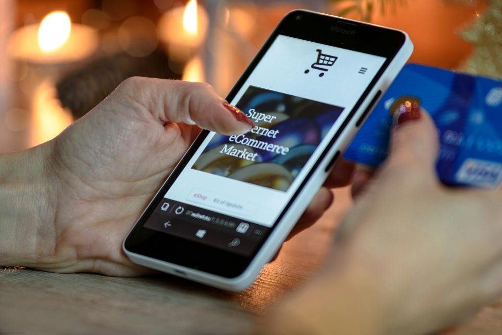 A shopper using augmented reality on a smartphone to preview a product in a virtual space.